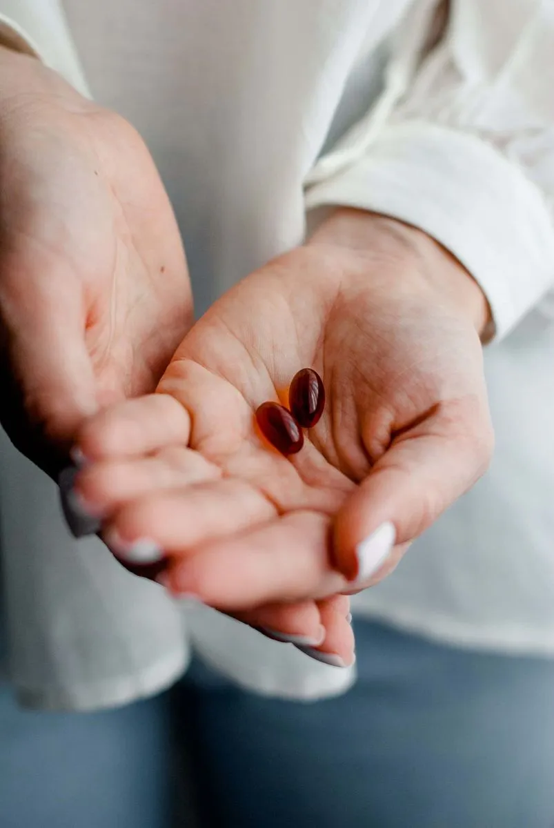 A pair of hands holding vitamins for anxiety.