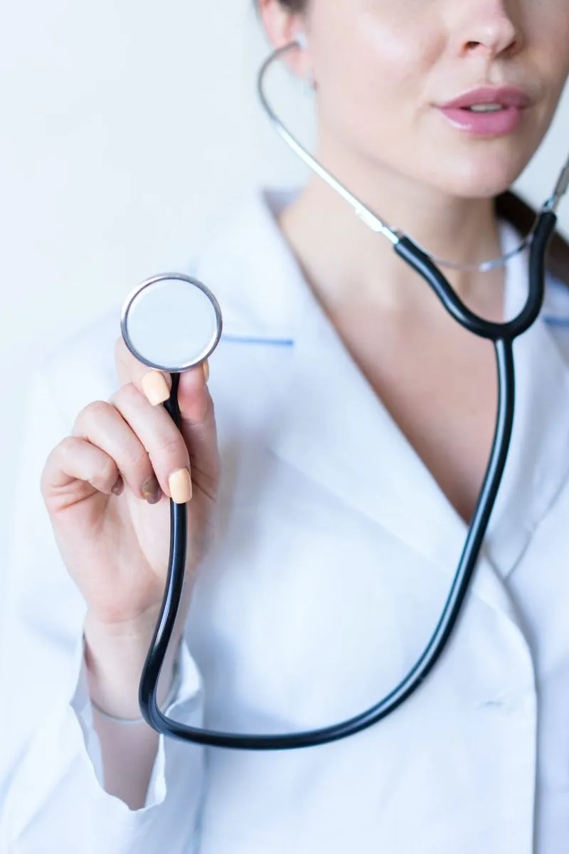 A female doctor using a stethoscope. 